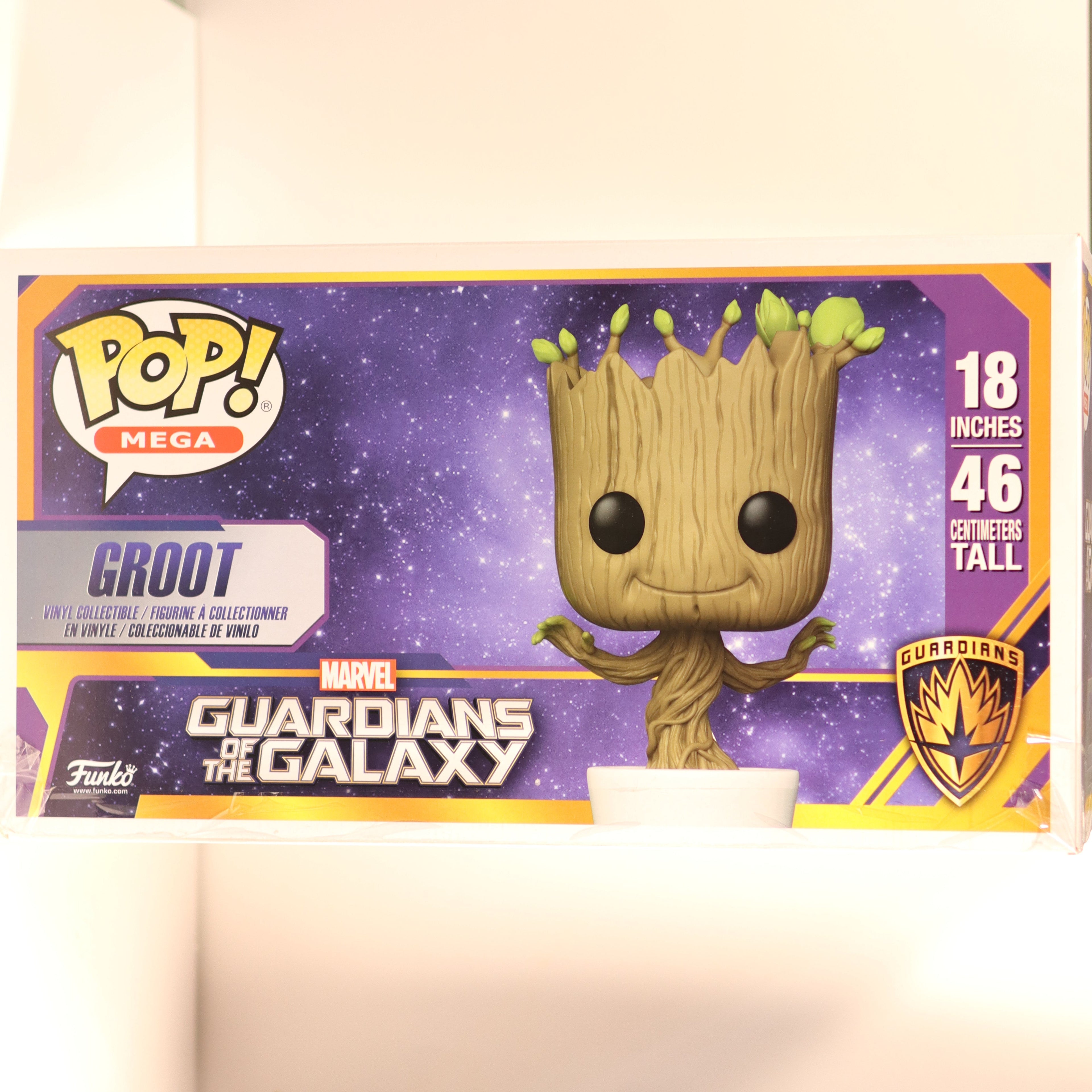 Box packaging of a Marvel Guardians of the Galaxy Groot figure with purple and yellow design.