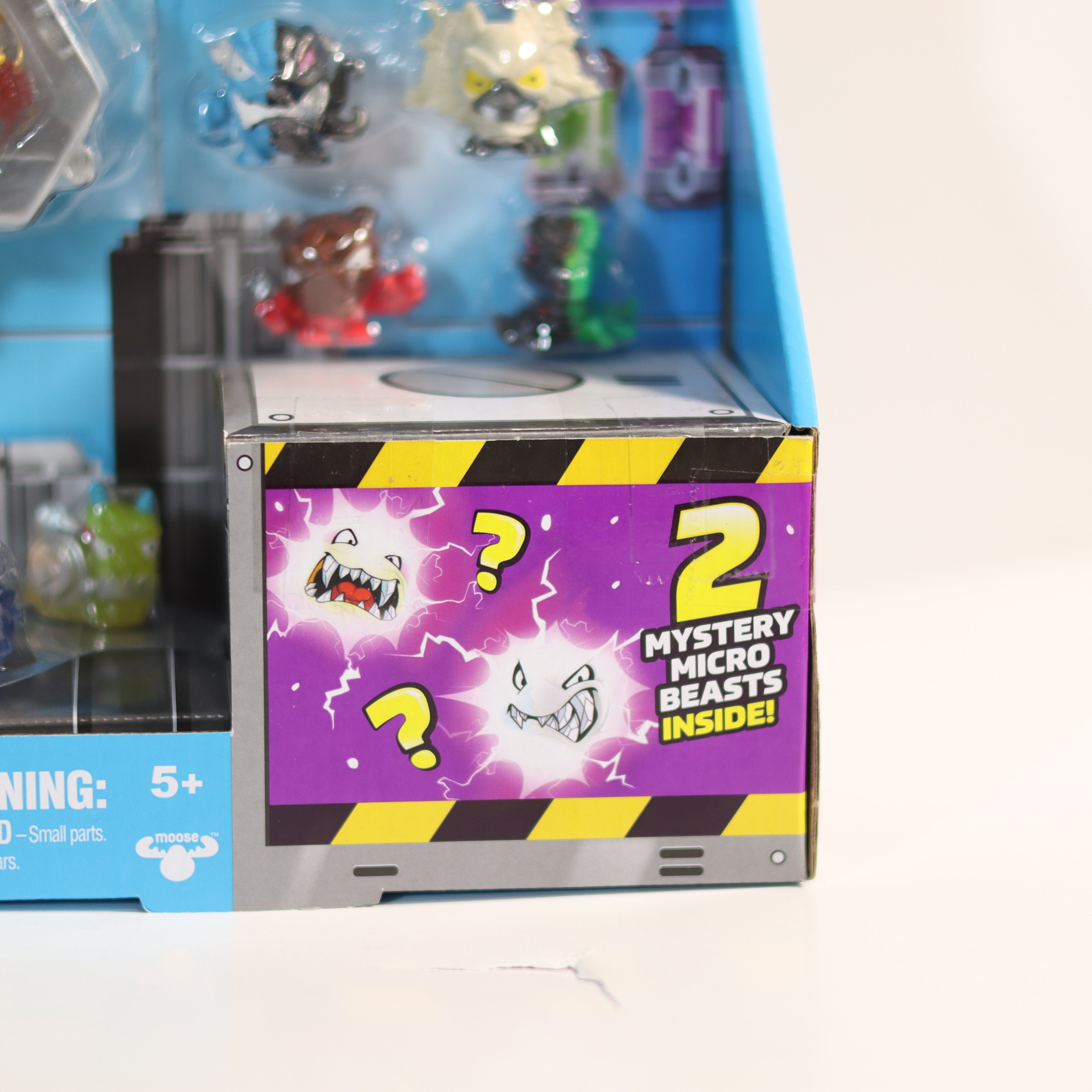 Toy box with '2 Mystery Micro Beasts Inside' text on a white background
