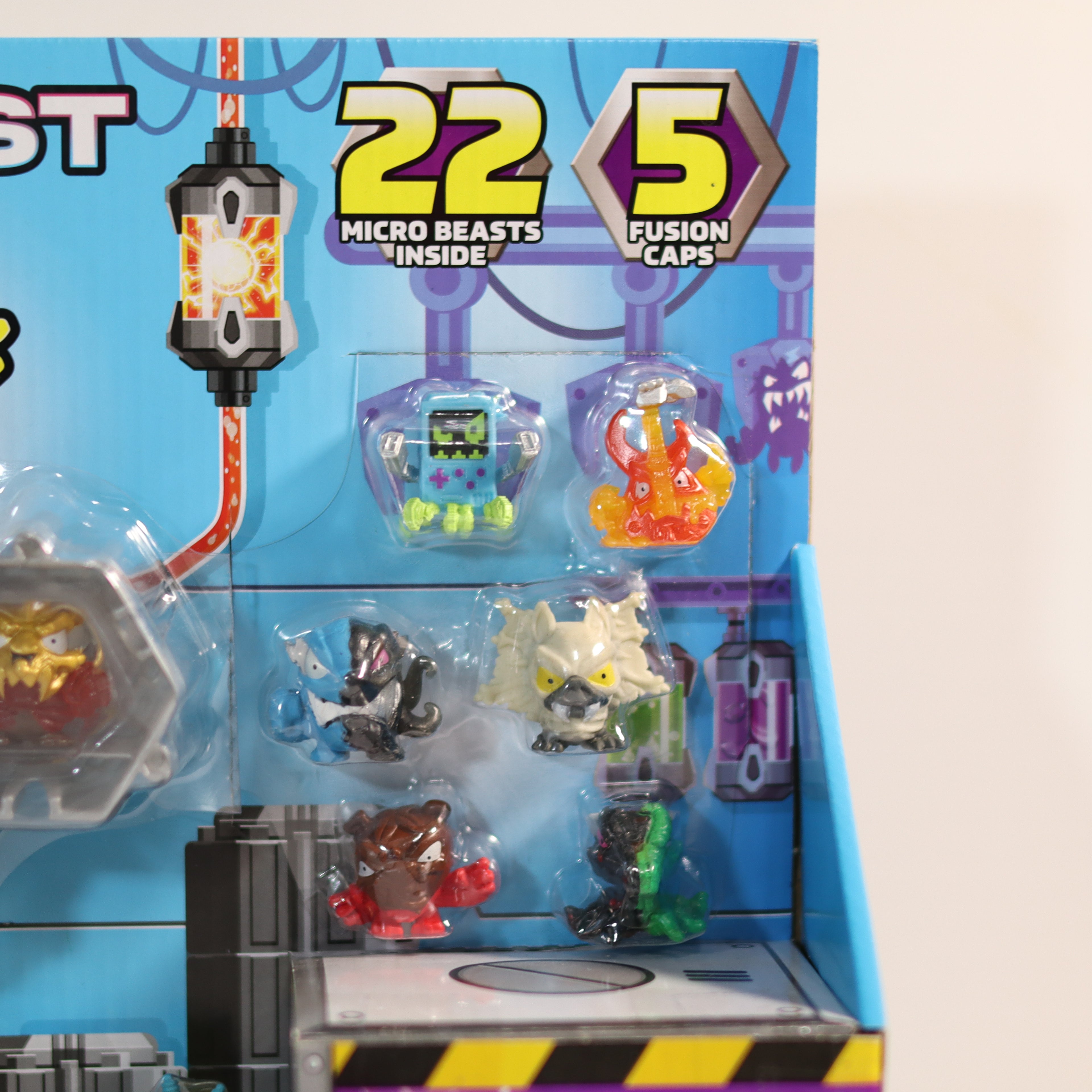 Toy packaging with micro beasts and fusion caps on a blue background