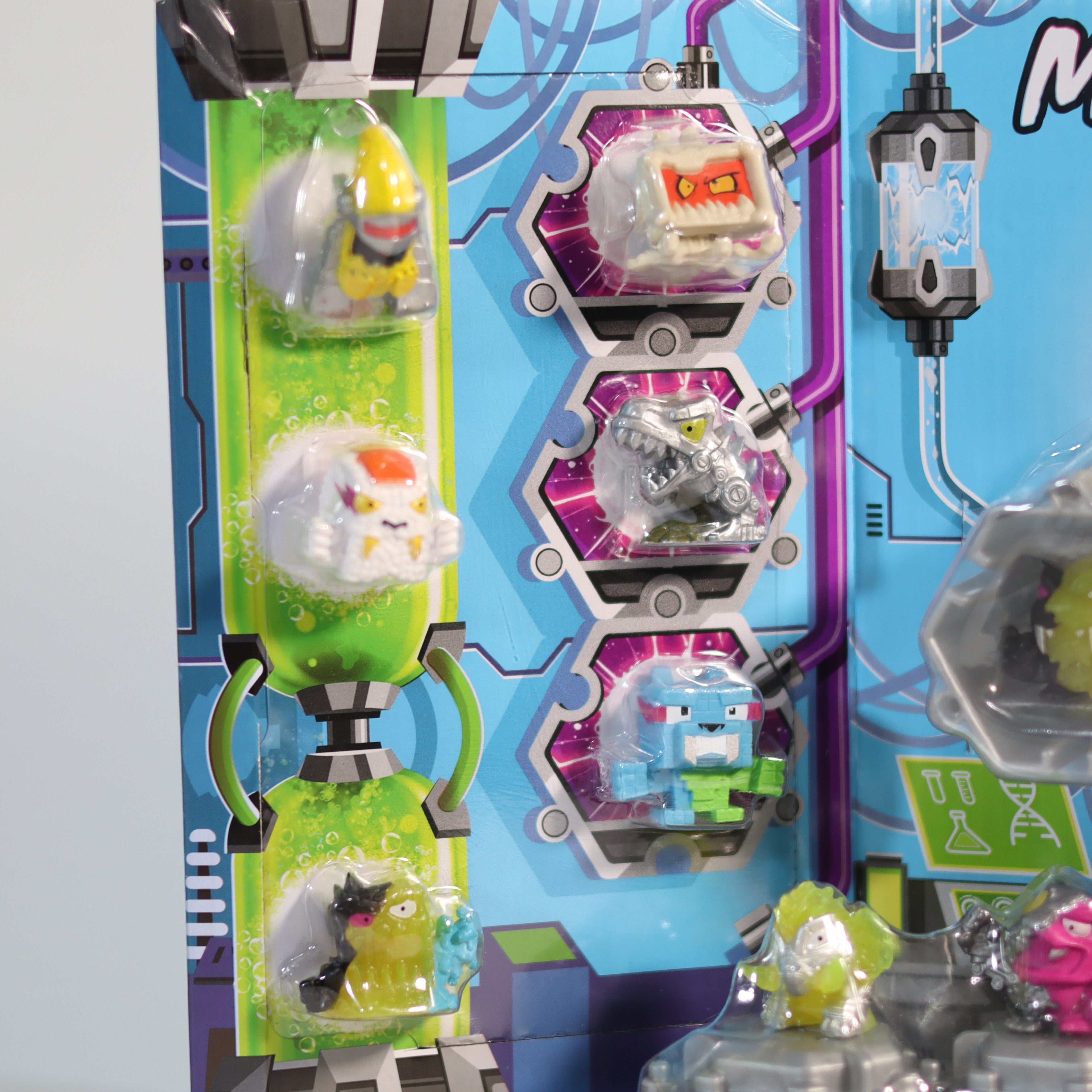 Toy packaging with various toy figures and colorful design elements on a blue background