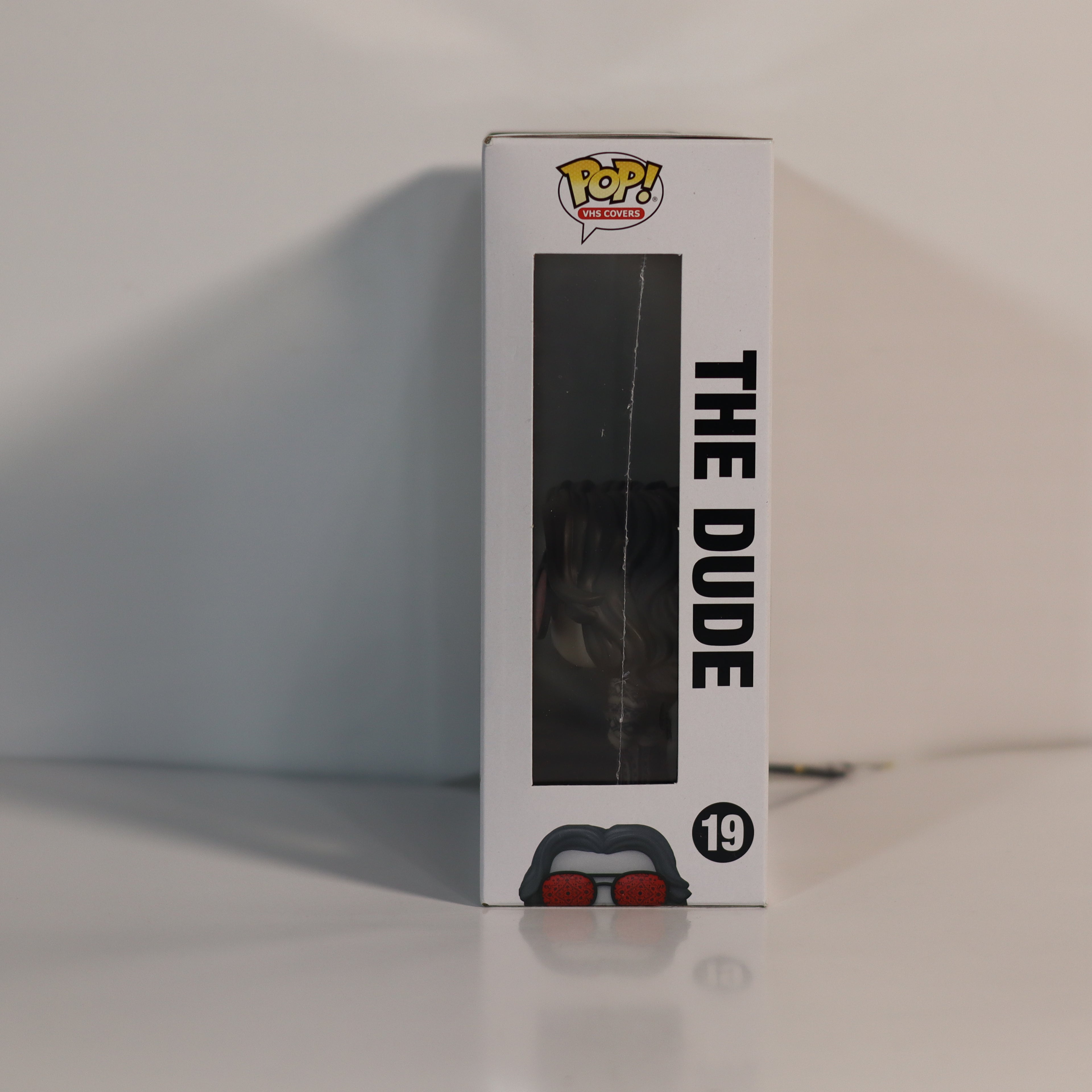 Funko Pop! vinyl figure packaging with 'The Dude' text on a white background