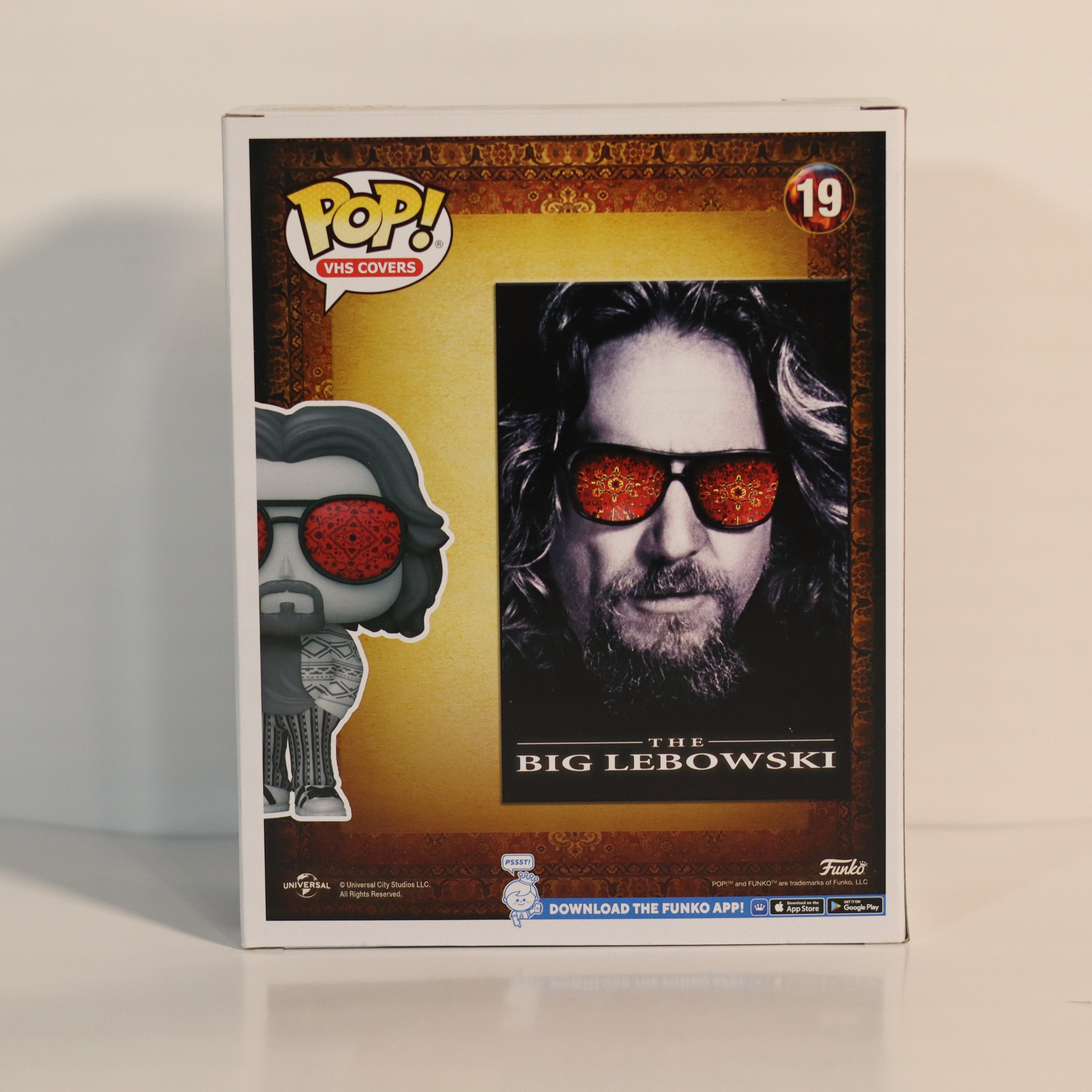 Pop! Vinyl figure packaging featuring a character from 'The Big Lebowski' with sunglasses.