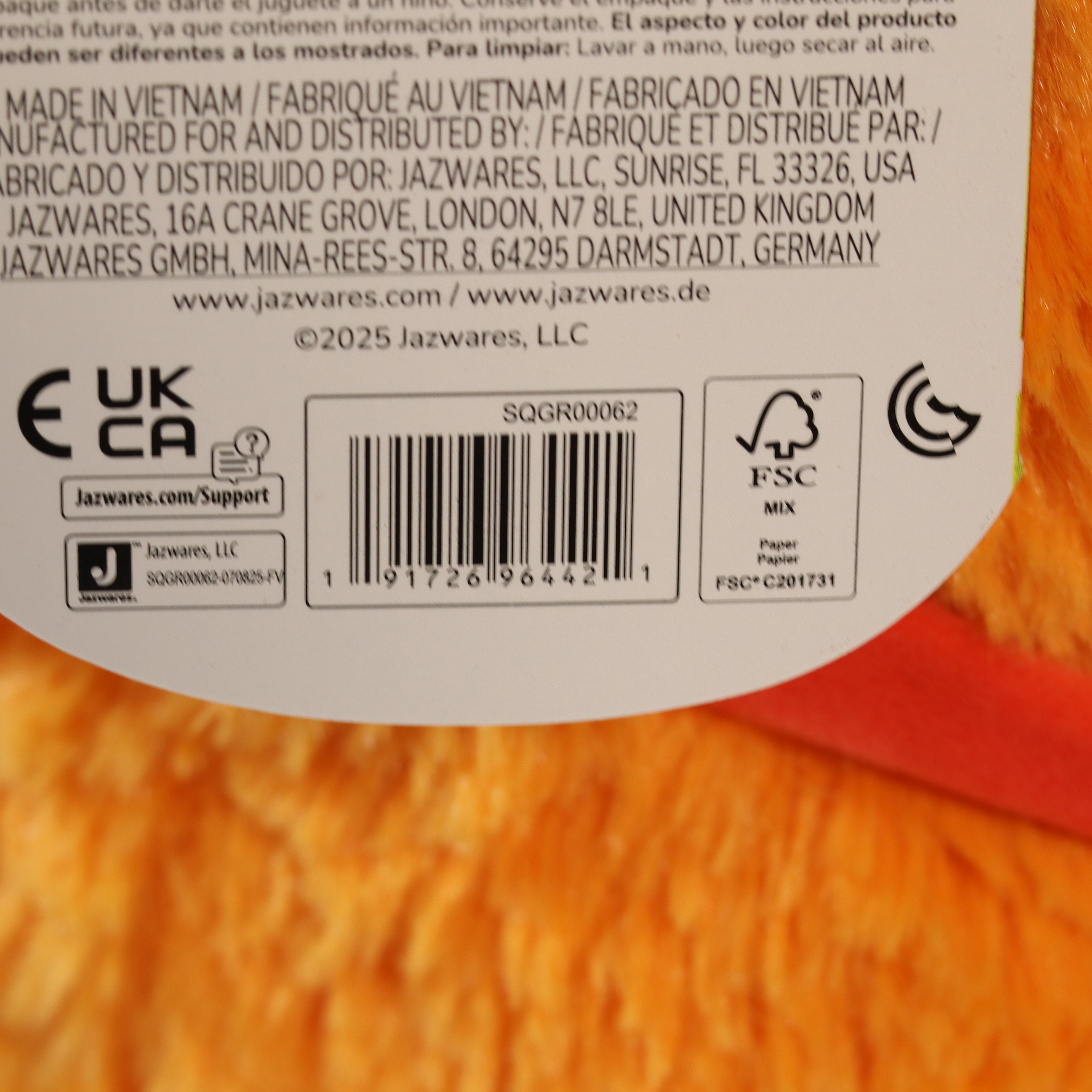Back of a product packaging with text, barcodes, and logos on a red background