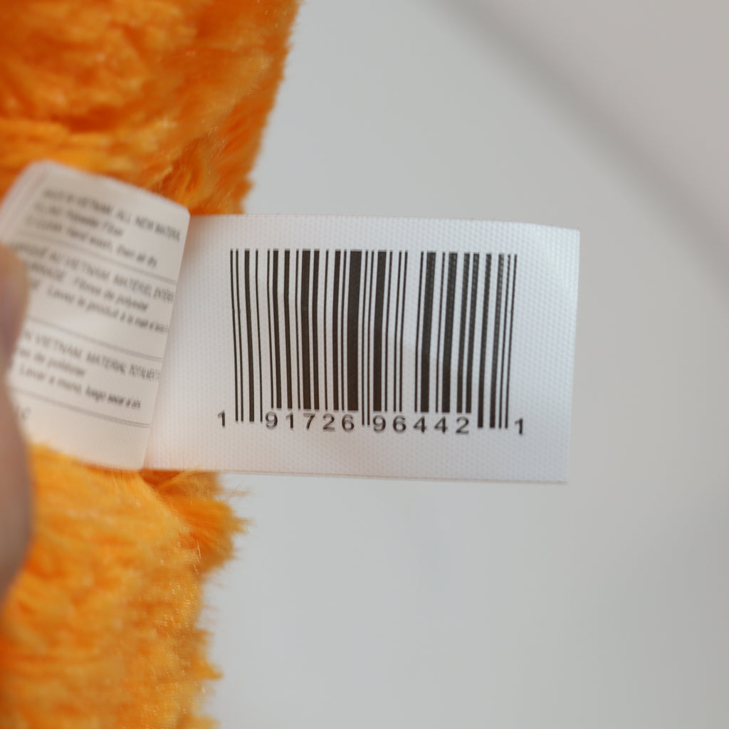 Close-up of a barcode label on a product with orange texture.