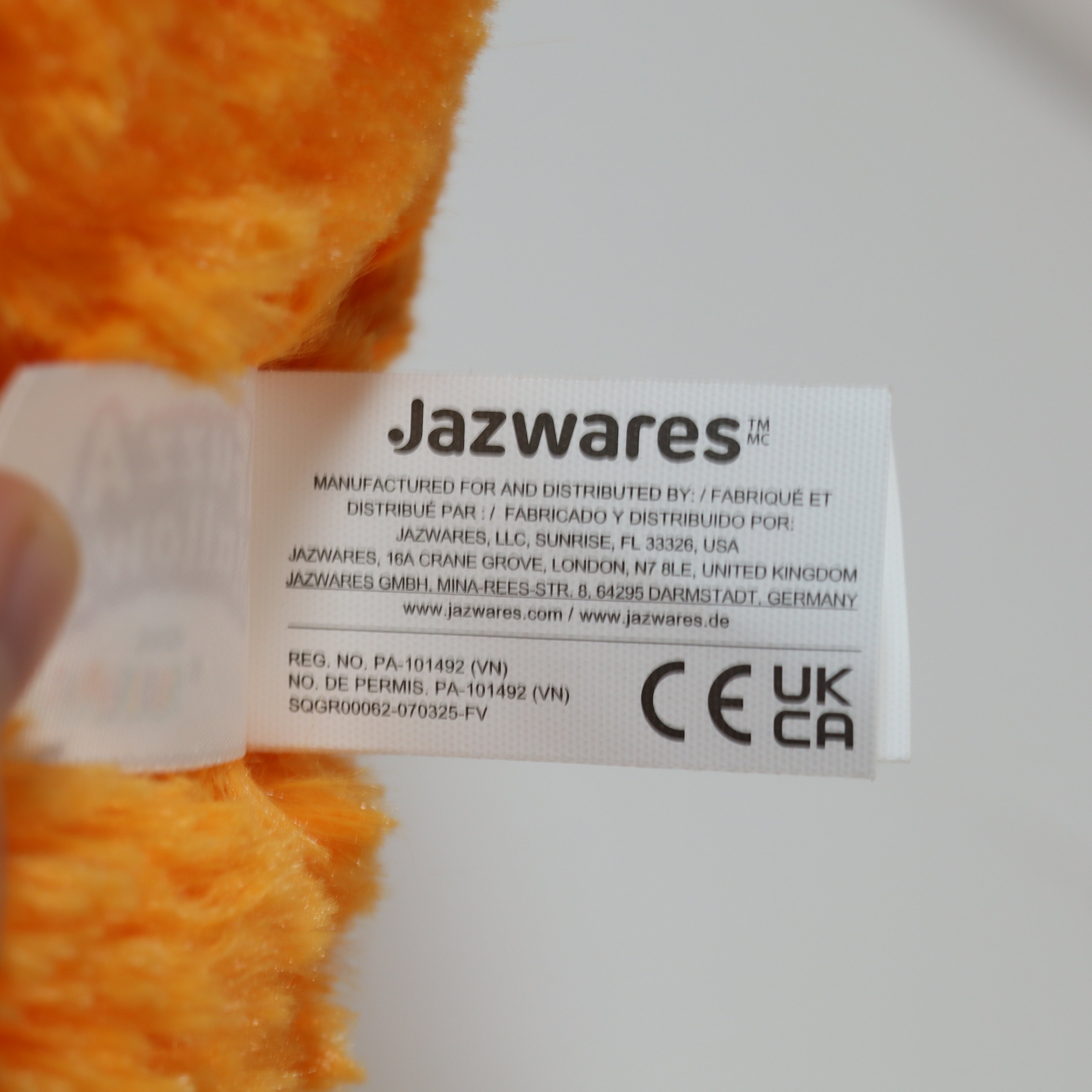Jazwares label on a toy with orange and white background