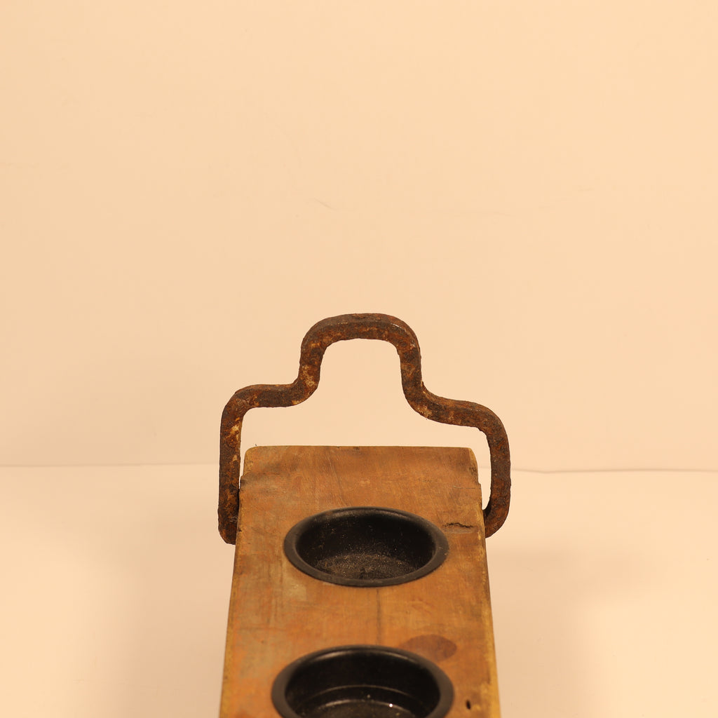 Vintage wooden tray with metal handles on a beige background