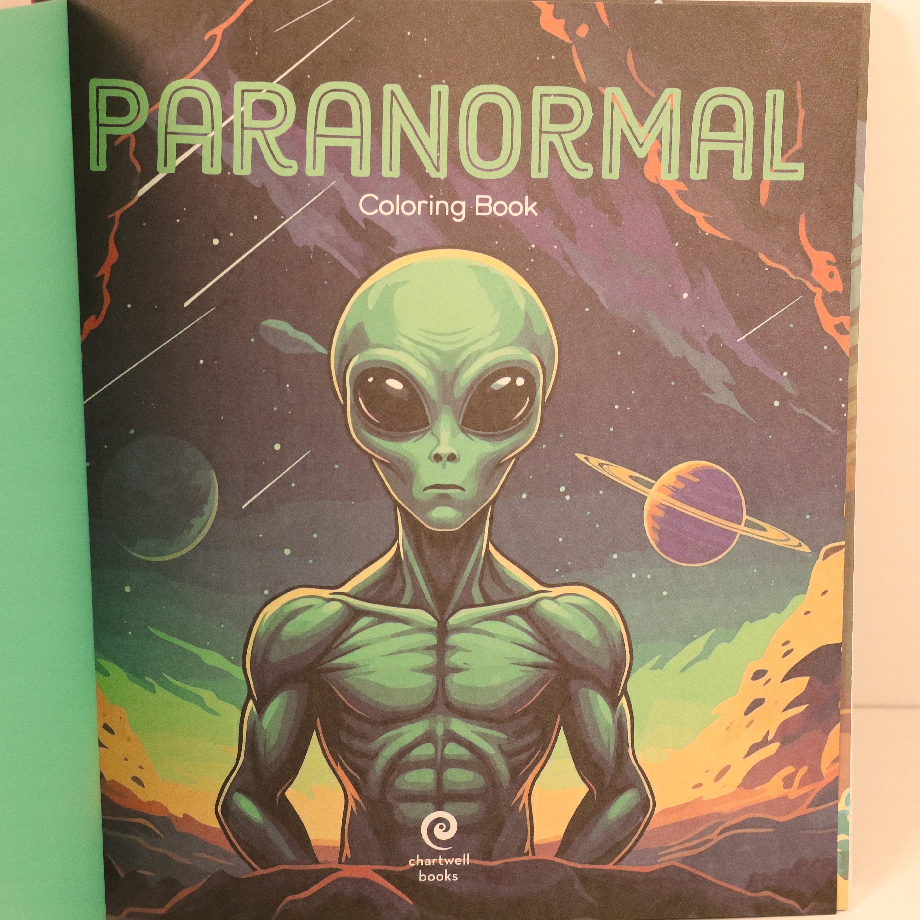 Coloring book cover with an alien illustration and 'Paranormal' text