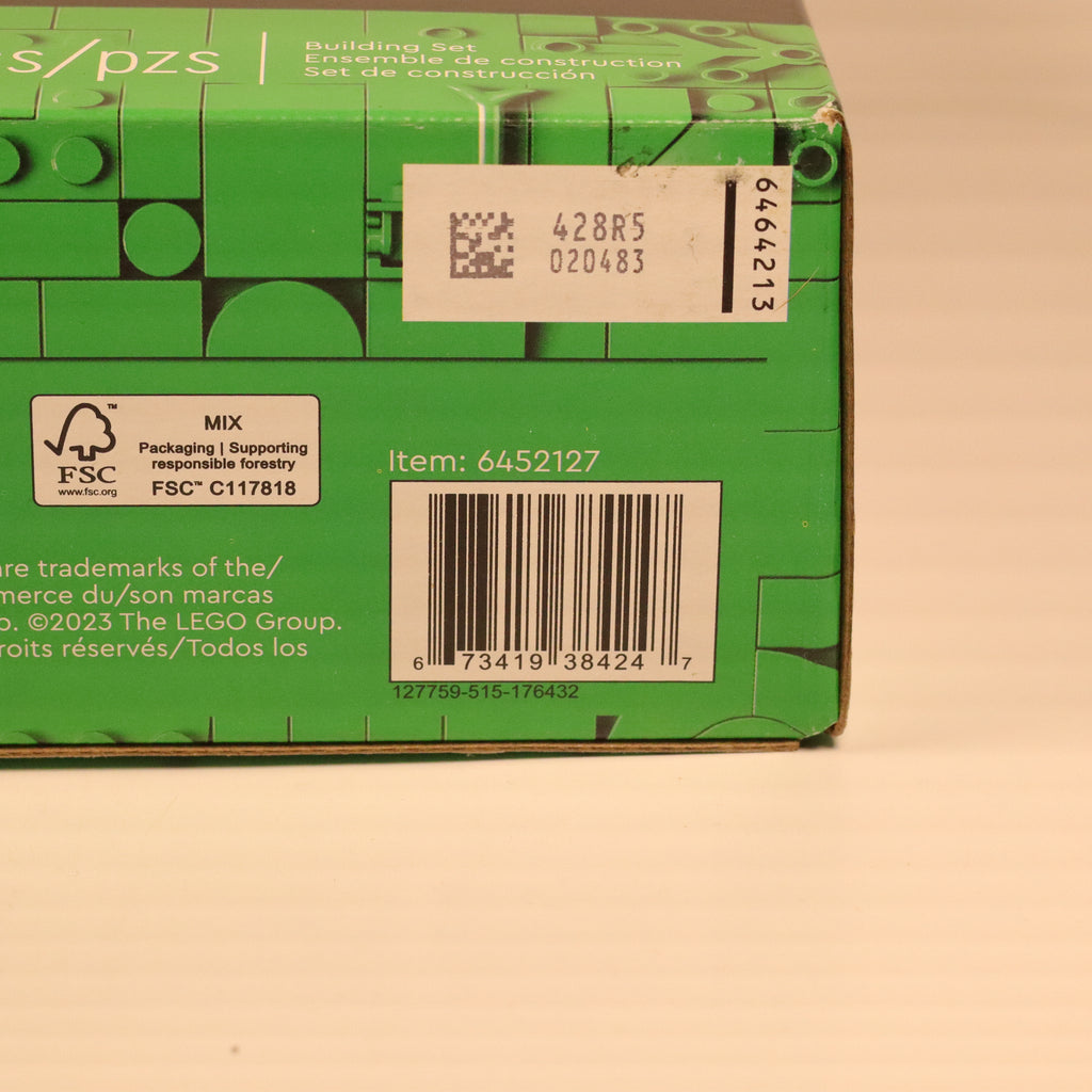 Green LEGO box with a barcode and text on a beige background