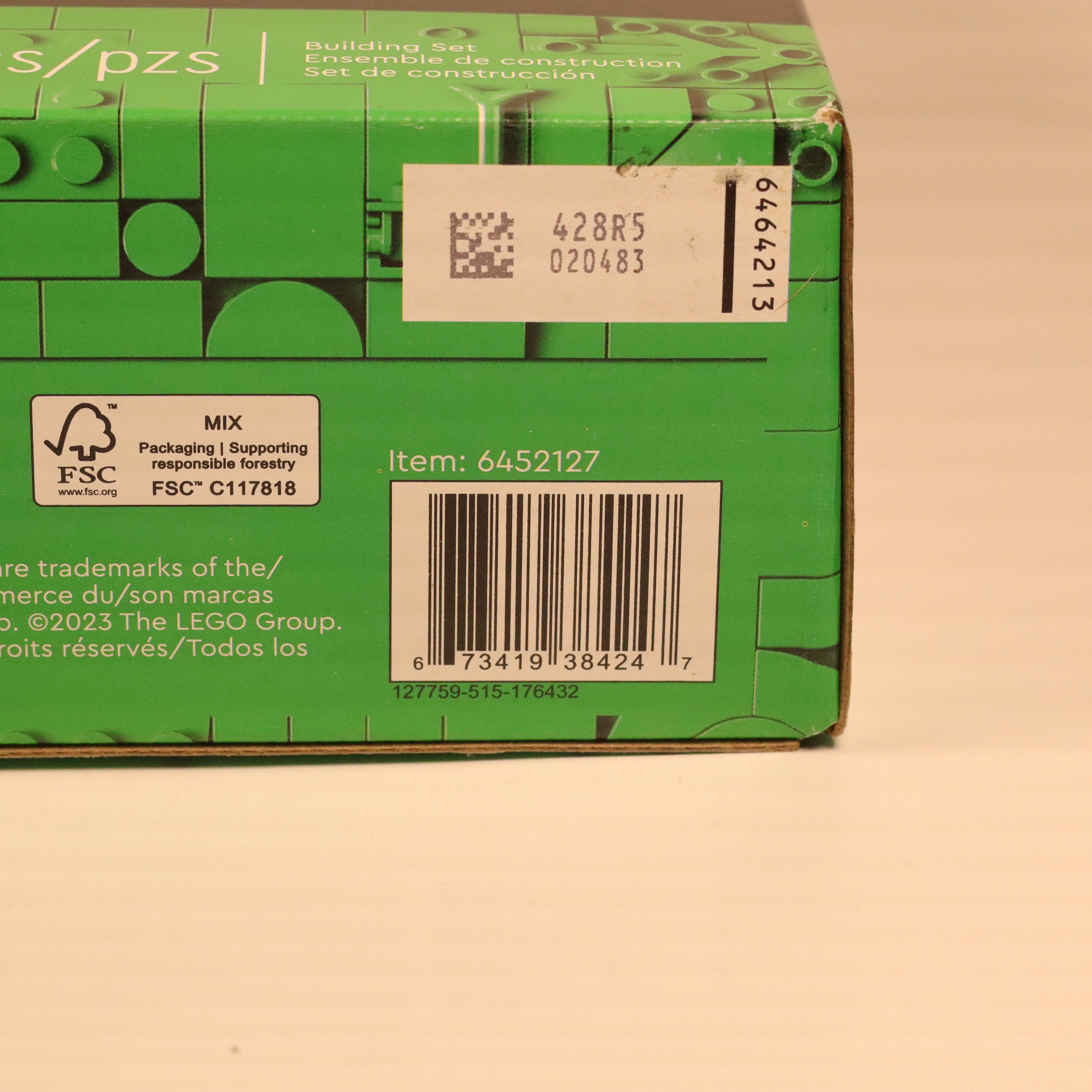 Green LEGO box with a barcode and text on a beige background