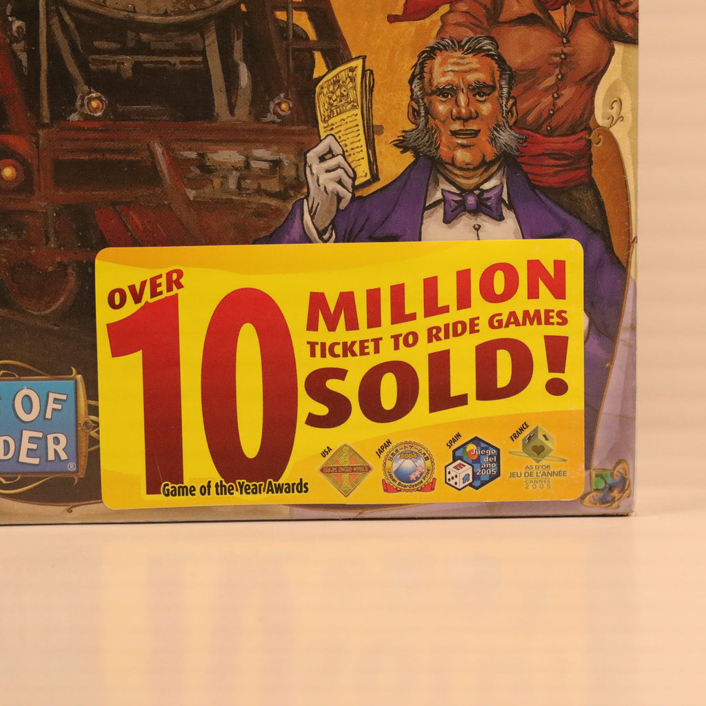 Board game box with a character holding a book and text about sales, on a beige background.
