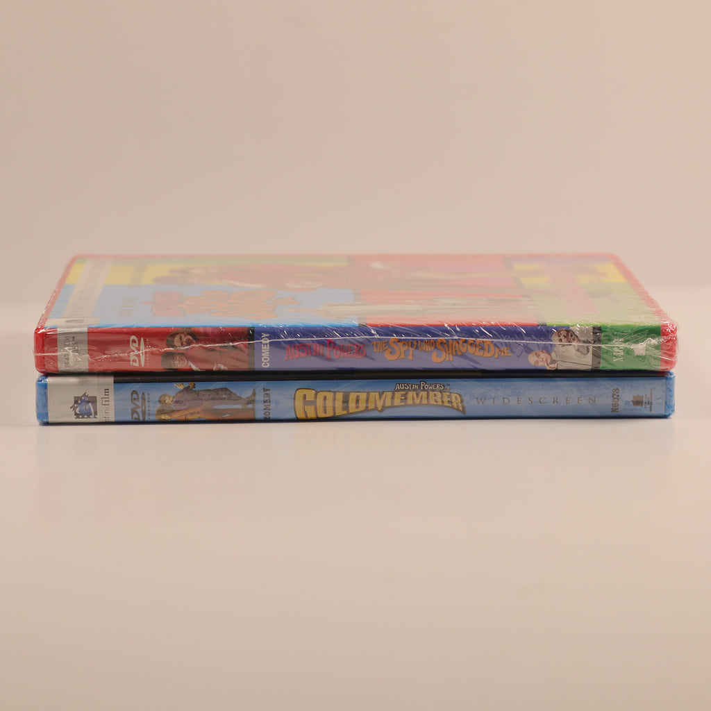 Two DVD cases stacked on a beige background