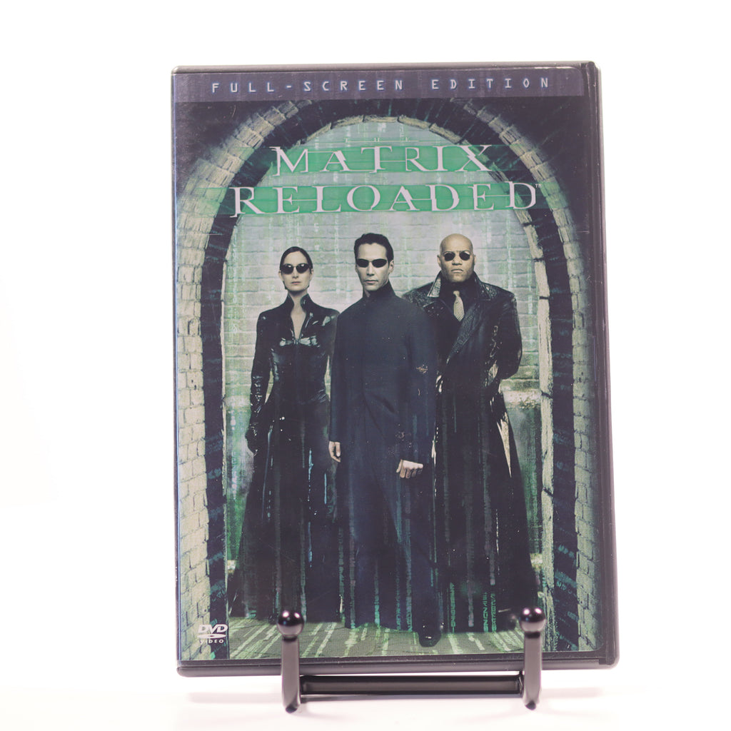 DVD cover of 'The Matrix Reloaded' with characters in black suits against a brick wall.