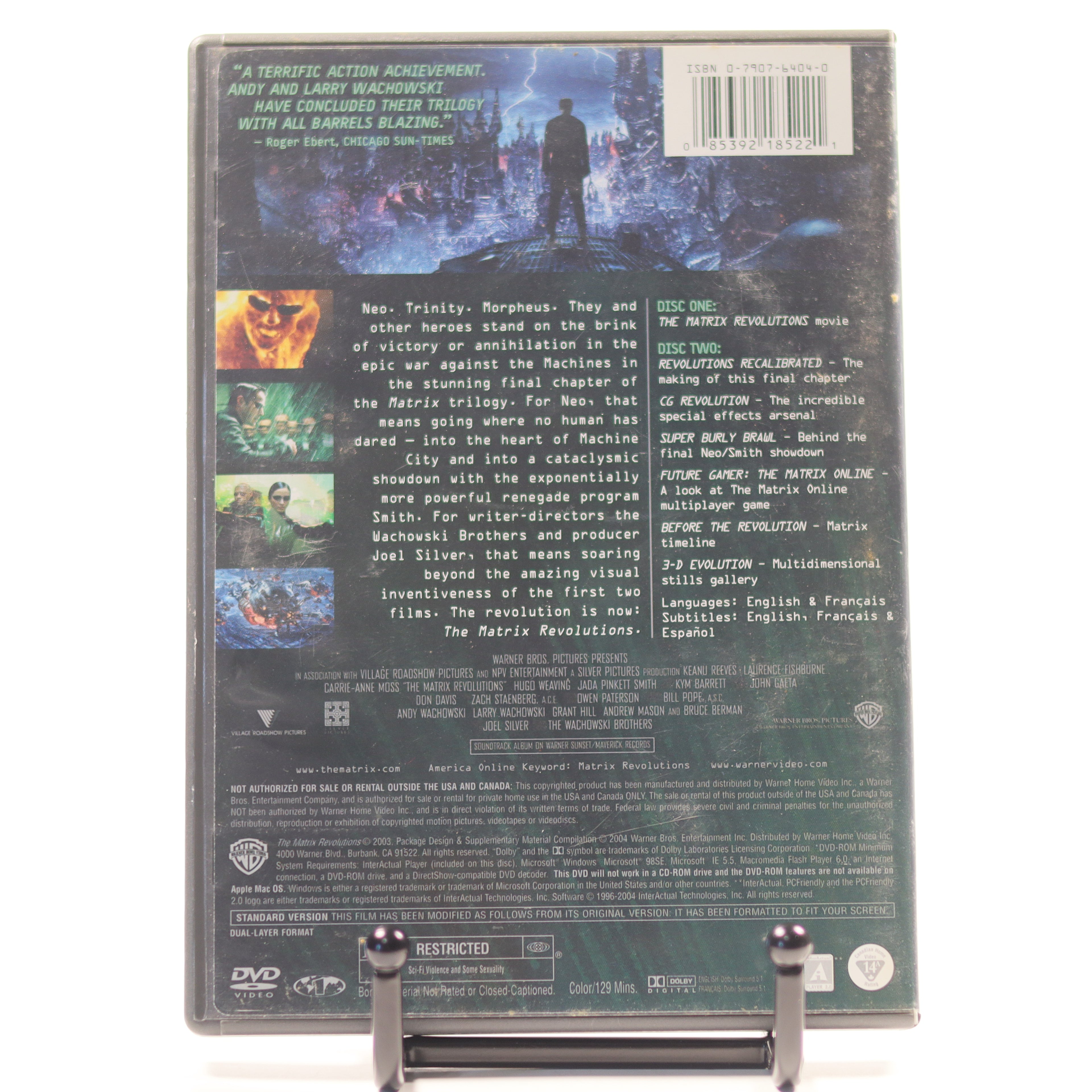 Back cover of a DVD set with text and images on a stand.