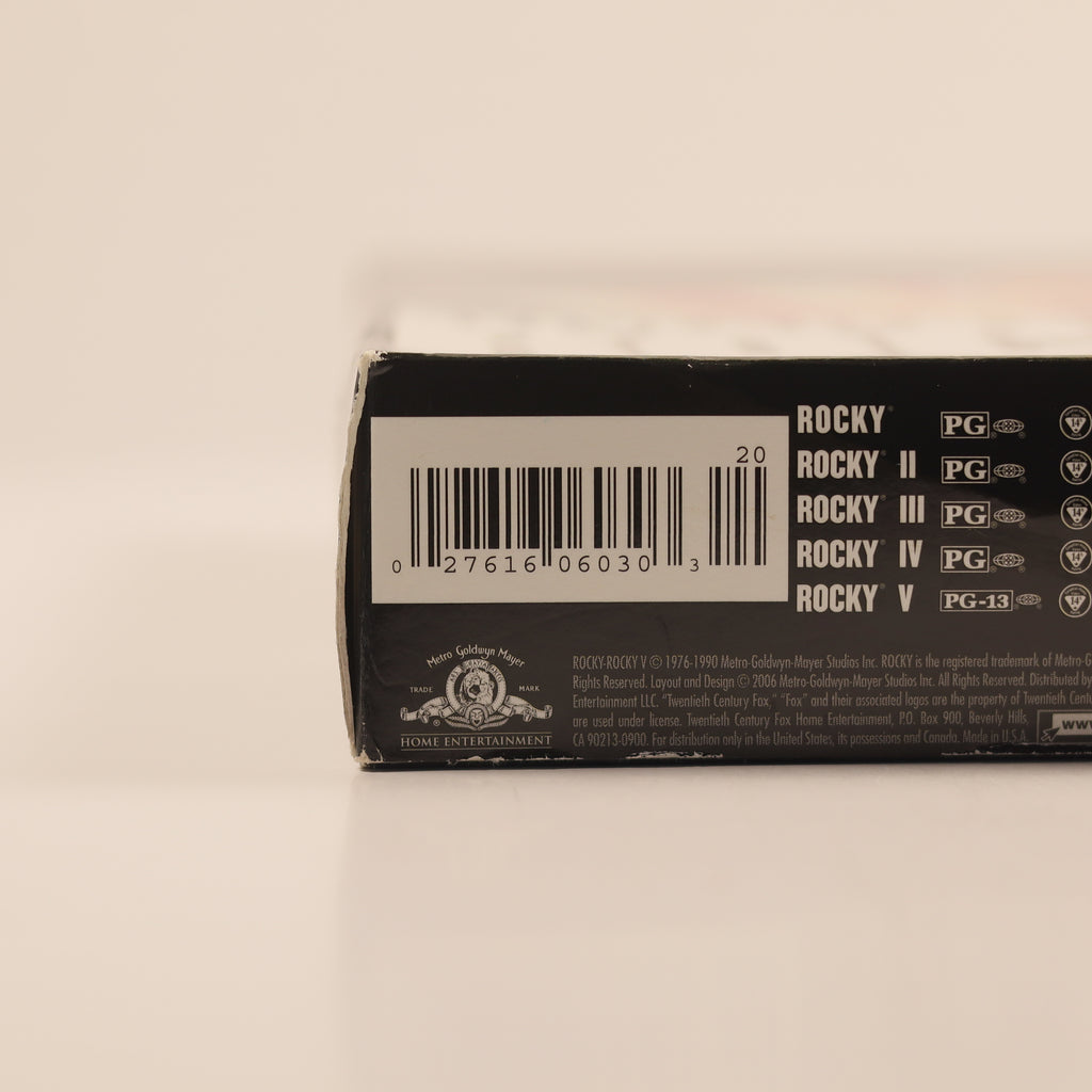 Close-up of a DVD case with 'Rocky' movie series branding on a beige background