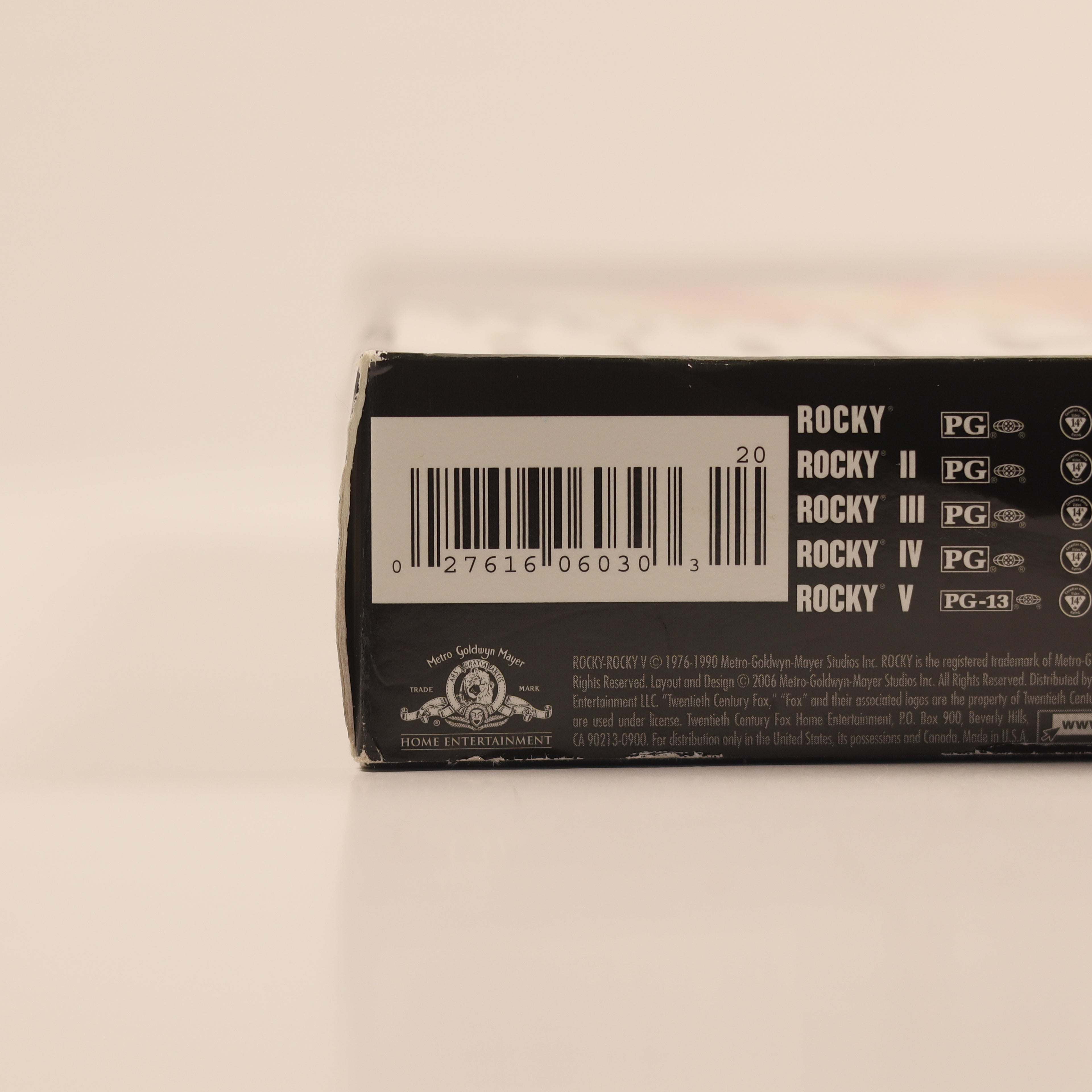 Close-up of a DVD case with 'Rocky' movie series branding on a beige background